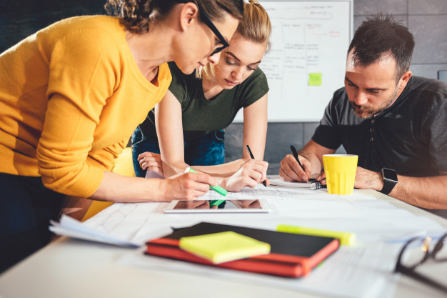 group-people-checking-blueprints_137573-2174